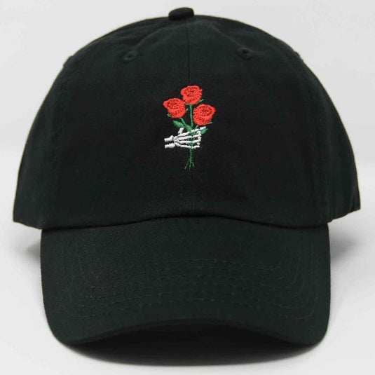front view of embroidered black hat with a skeleton hand holding red rose